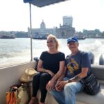 Premium Speedboat heading to Elephanta Island with the Gateway of India and Taj Mahal Palace Hotel in the background.