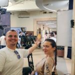 Tourists enjoying a behind-the-scenes Bollywood studio tour in Mumbai, witnessing live filming and exploring film sets — part of the Passport Lifestyles experience.